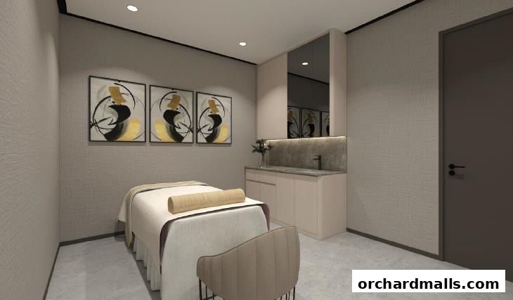 A serene treatment room with a massage bed, artwork, and a vanity area.