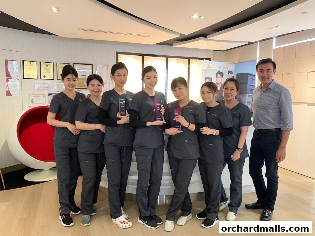 A team of medical professionals posing for a photo inside a clinic.