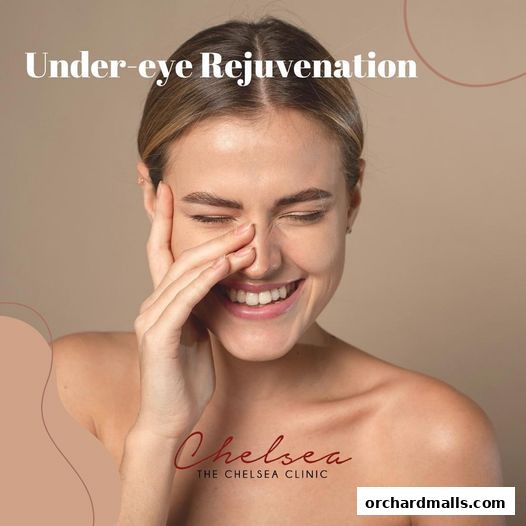 A smiling woman with her eyes closed, promoting under-eye rejuvenation.