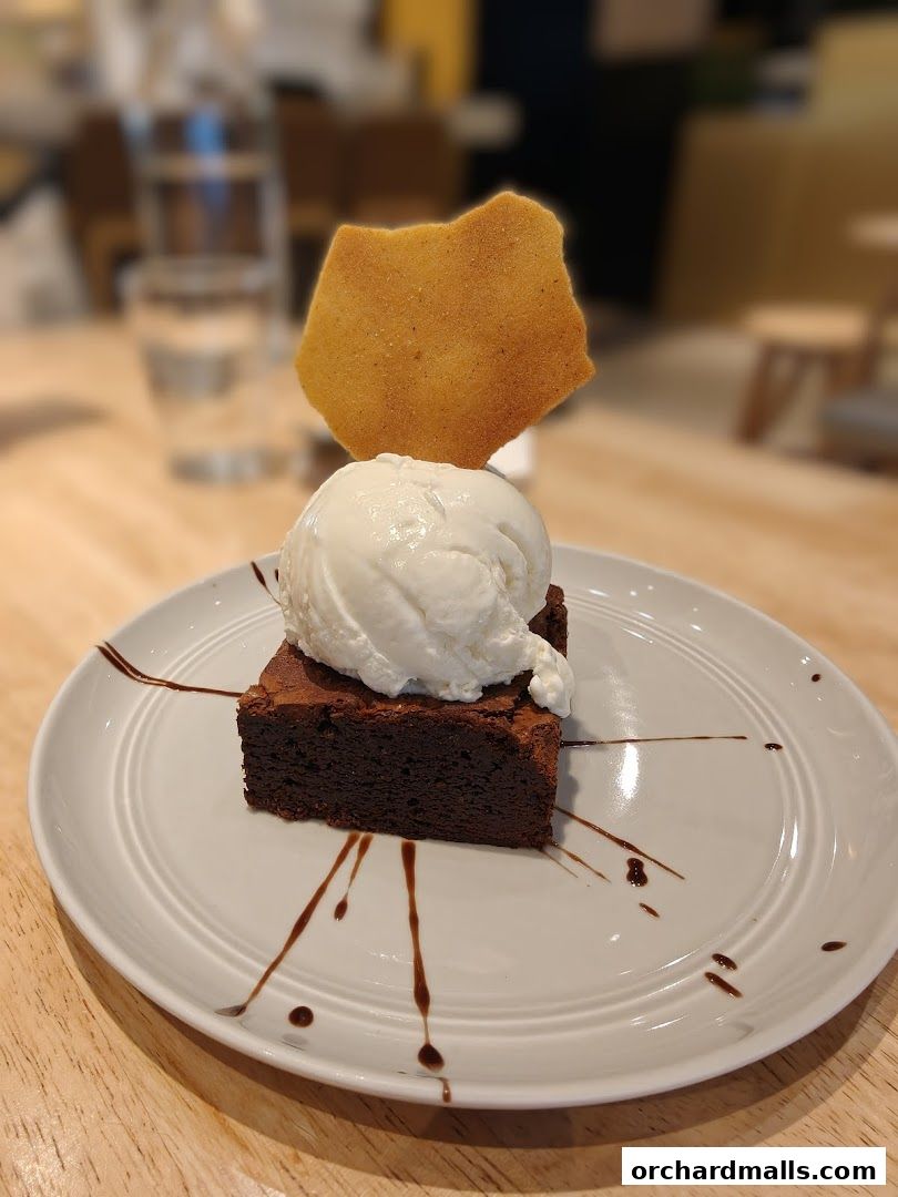 A decadent brownie topped with ice cream and a crunchy honeycomb shard.