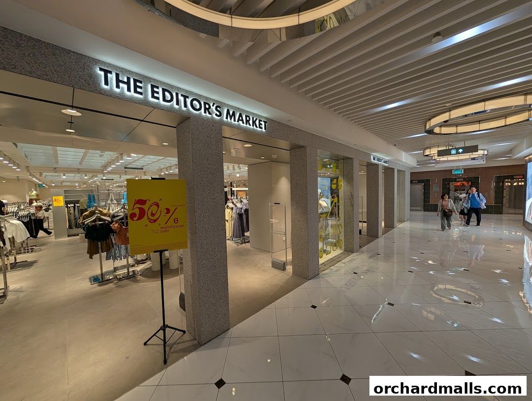 The Editors Market shop entrance with a 50% off warehouse sale sign.