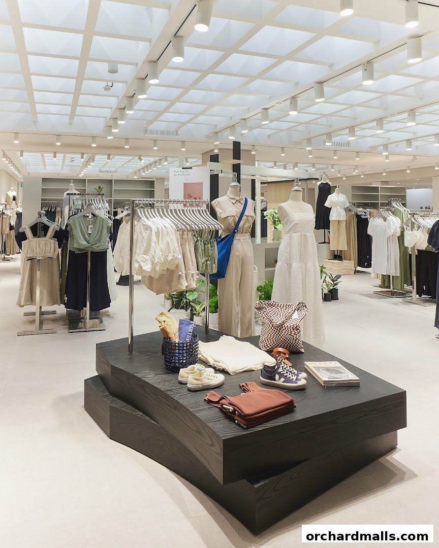 Interior view of The Editors Market clothing store with mannequins and apparel on display.
