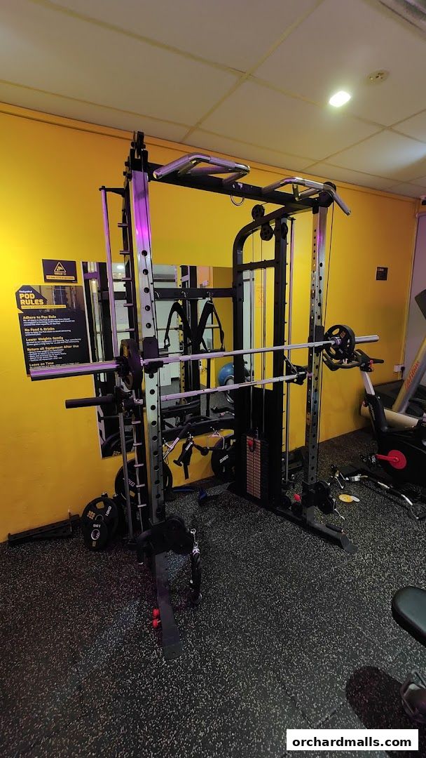 Interior view of a gym with a multi-functional weight machine and exercise equipment.