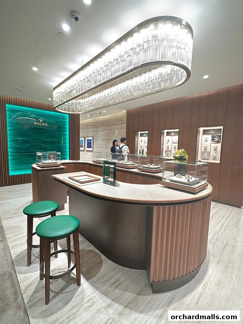 Interior of a luxury watch retailer showcasing Rolex and Patek Philippe displays.