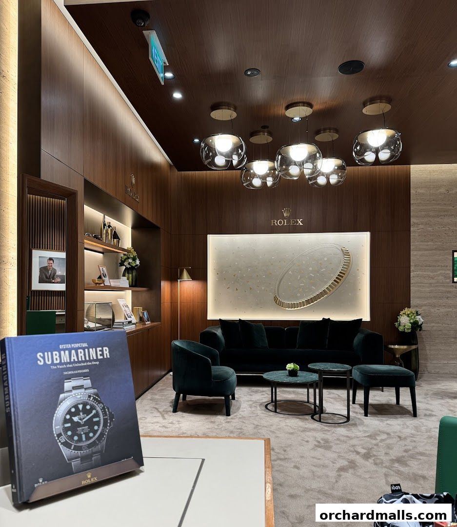 Interior of a luxury watch retailer featuring Rolex and Patek Philippe displays and seating.