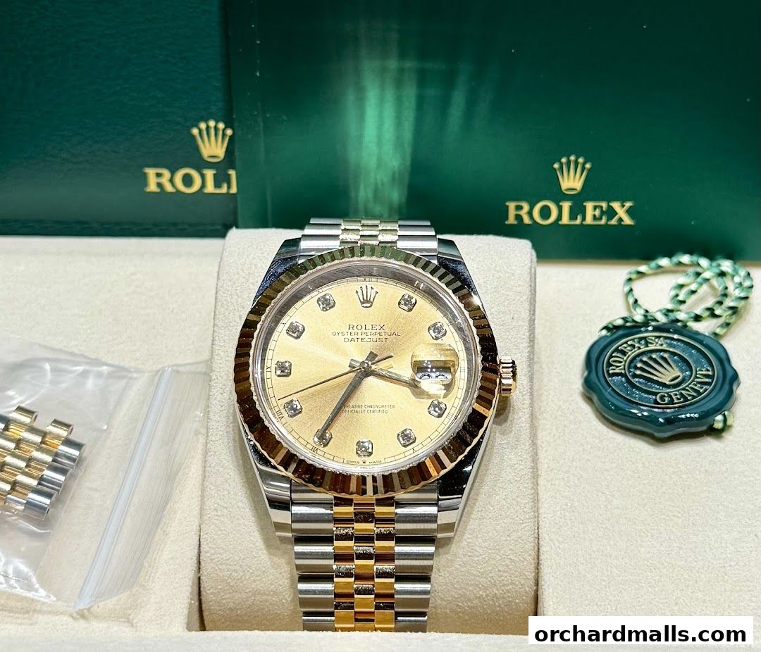 A luxurious Rolex watch with a gold dial and diamond markers, presented with its box and seal.