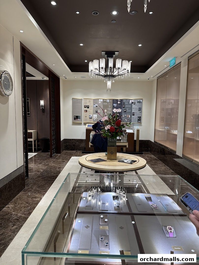 Interior of a luxury watch store showcasing display cases with watches and historical displays.