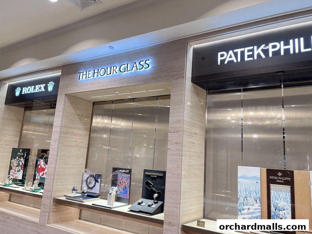 The Hour Glass store featuring Rolex and Patek Philippe displays and signage.