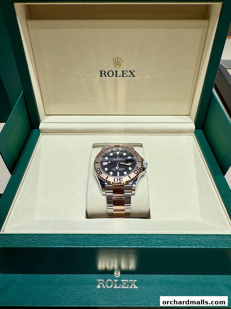 A luxurious Rolex watch displayed in its official green and gold presentation box.