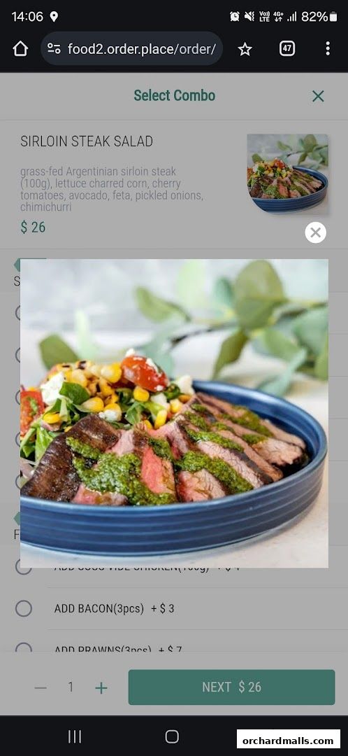 A close-up of a Sirloin Steak Salad with corn, tomatoes, and feta cheese.