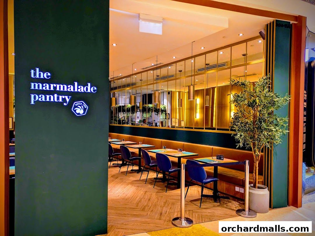 The entrance to The Marmalade Pantry cafe bistro with seating visible inside.