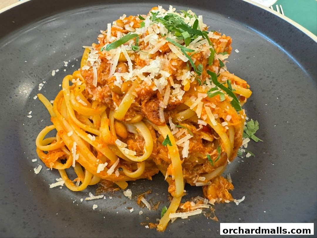 A close-up shot of a delicious pasta dish topped with sauce, cheese, and herbs.
