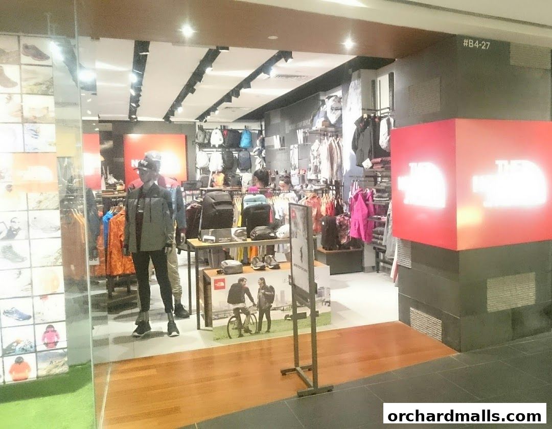 The North Face store interior showcasing apparel, backpacks, and mannequins with outdoor gear.