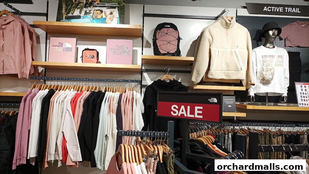 Interior view of The North Face store showcasing apparel, backpacks, and a sale sign.