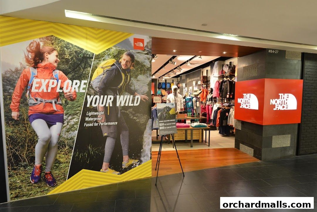 The North Face store entrance with promotional graphics and merchandise displayed inside.
