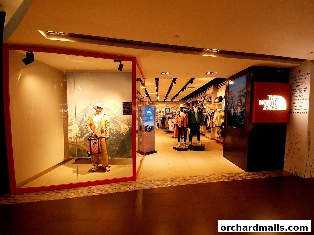 The North Face store entrance with mannequins displaying outdoor gear and the brand's logo.