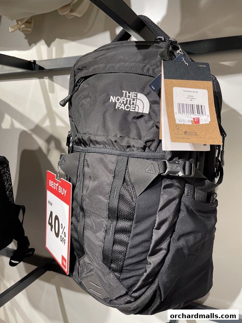 A black North Face backpack with a "Best Buy 40% Off" tag and product tag.