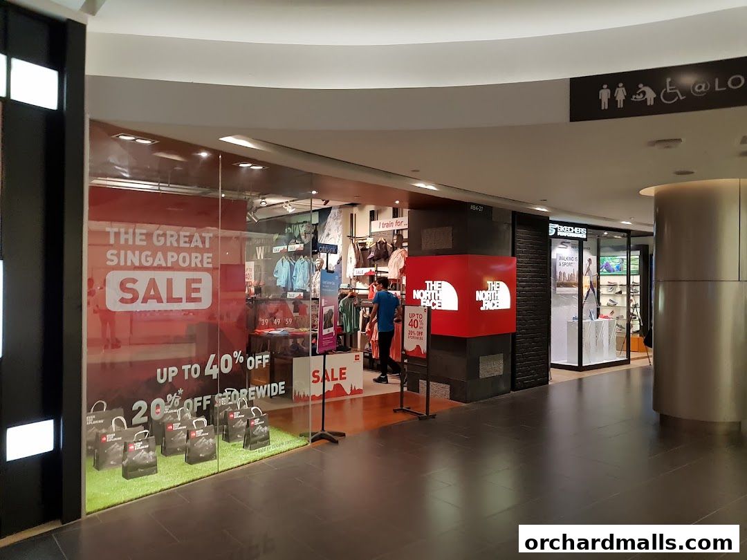 The North Face store entrance with a large 'The Great Singapore Sale' banner and promotional displays.