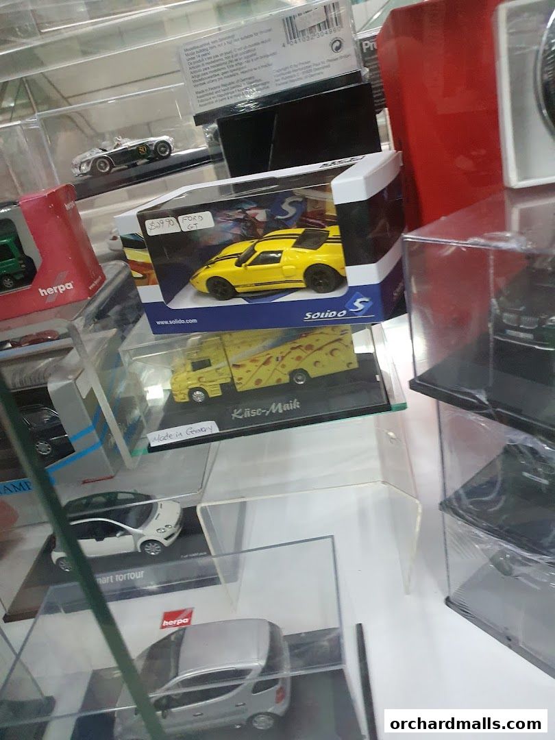 A display case filled with various collectible model cars and trucks.