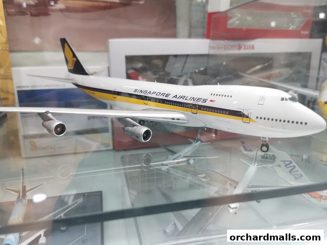 A detailed model of a Singapore Airlines airplane is displayed in a shop.