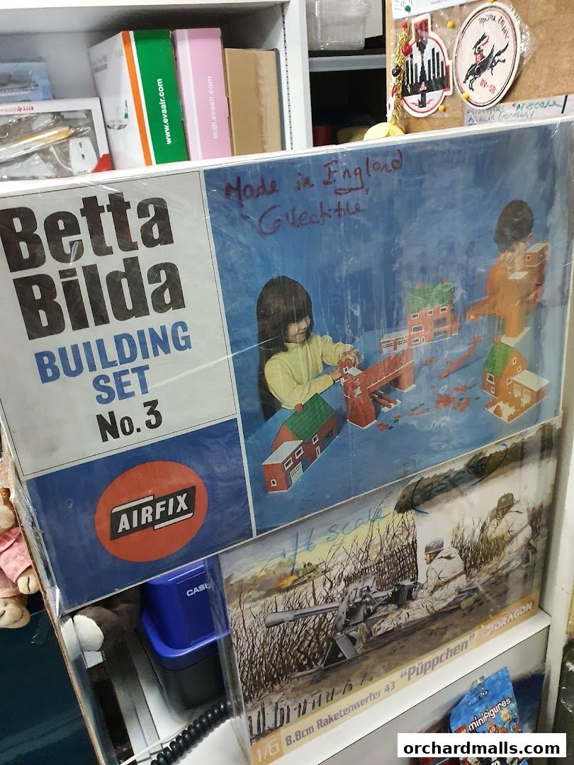 Boxes of Airfix building sets and model kits displayed on shelves.