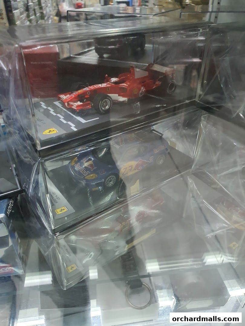 Display of detailed model race cars in clear protective cases.