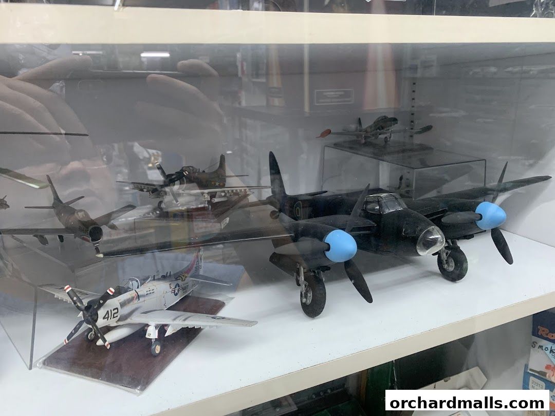 Display case filled with detailed model airplanes, showcasing various aircraft designs.
