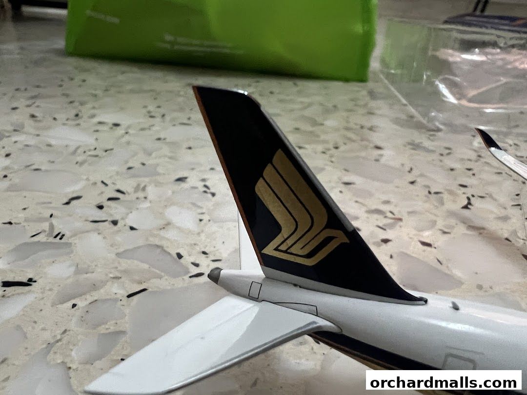 Close-up of a model airplane tail with the Singapore Airlines logo.