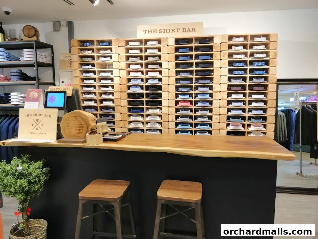 Interior of The Shirt Bar showing a display of folded shirts and a wooden counter.