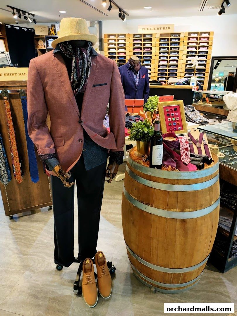 Mannequin dressed in a stylish suit with accessories displayed in a shirt shop.