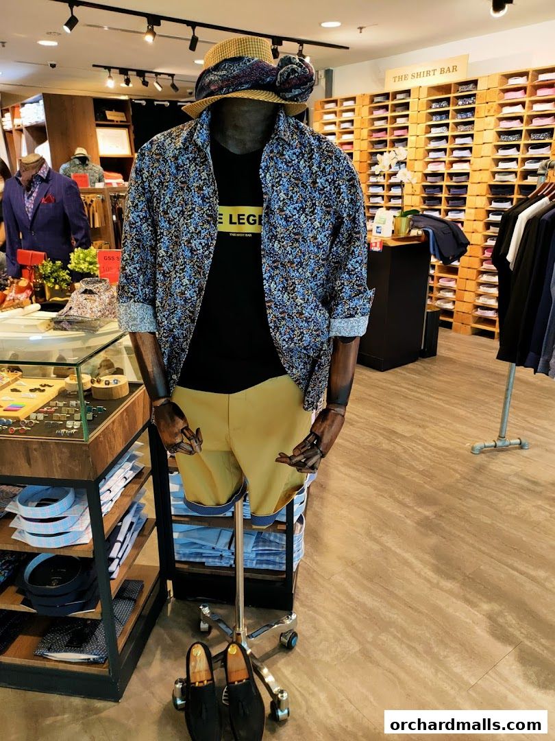 Mannequin dressed in a patterned shirt, black t-shirt, and shorts at The Shirt Bar.