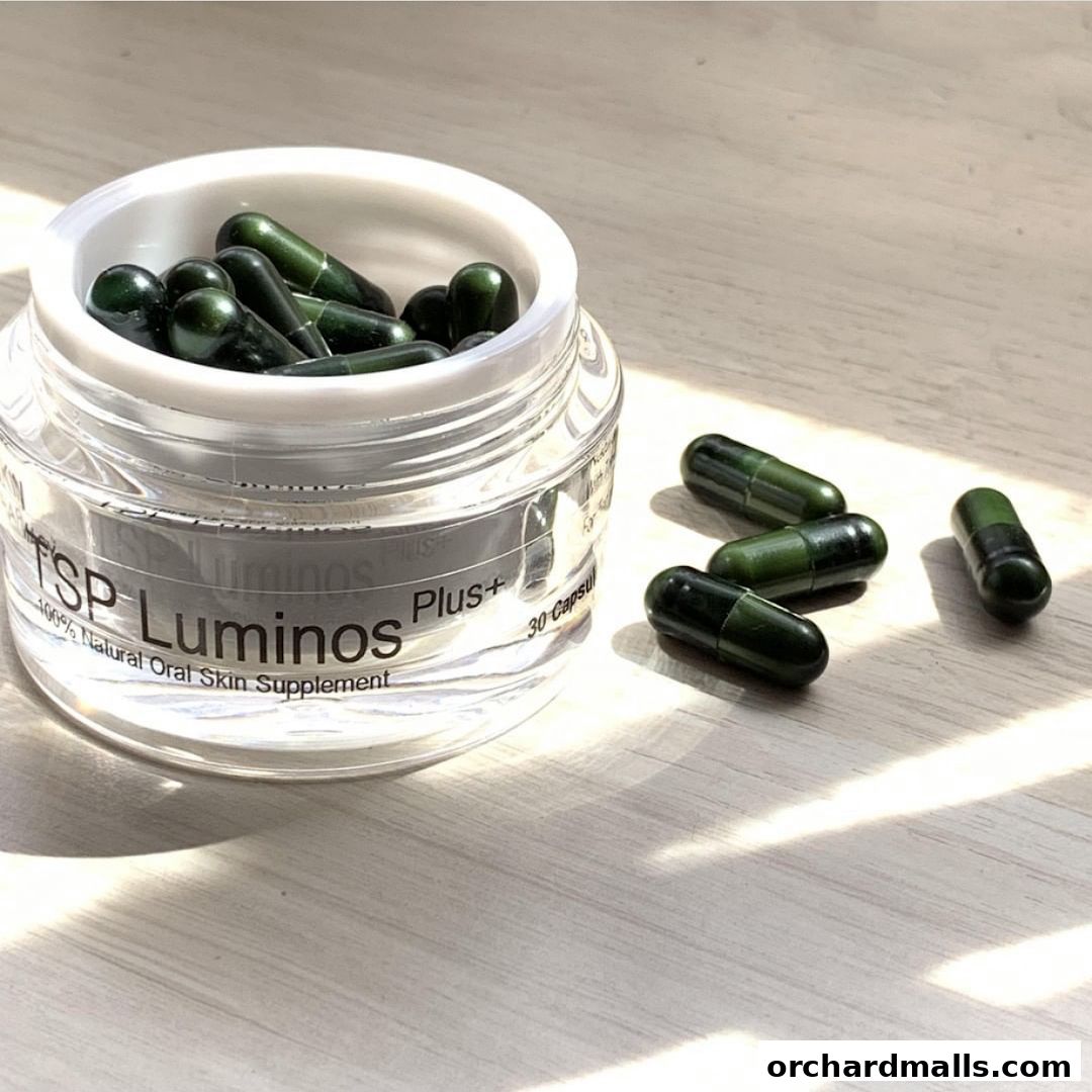 A jar of green skin supplement capsules with some scattered around.