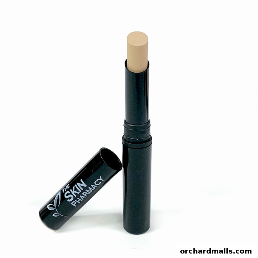 A close-up of a concealer stick with its cap off, showcasing the product.