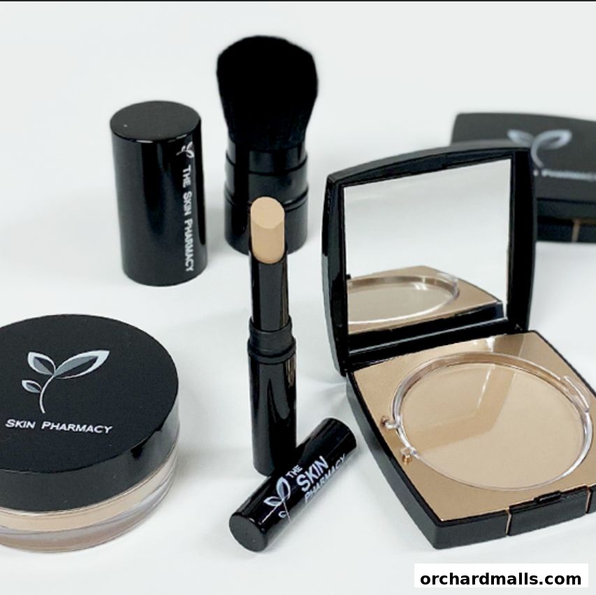 A collection of makeup products from The Skin Pharmacy, including foundation, concealer, and a brush.