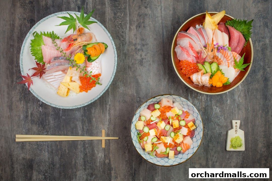 Three bowls of Japanese sashimi and rice dishes, with chopsticks and wasabi.