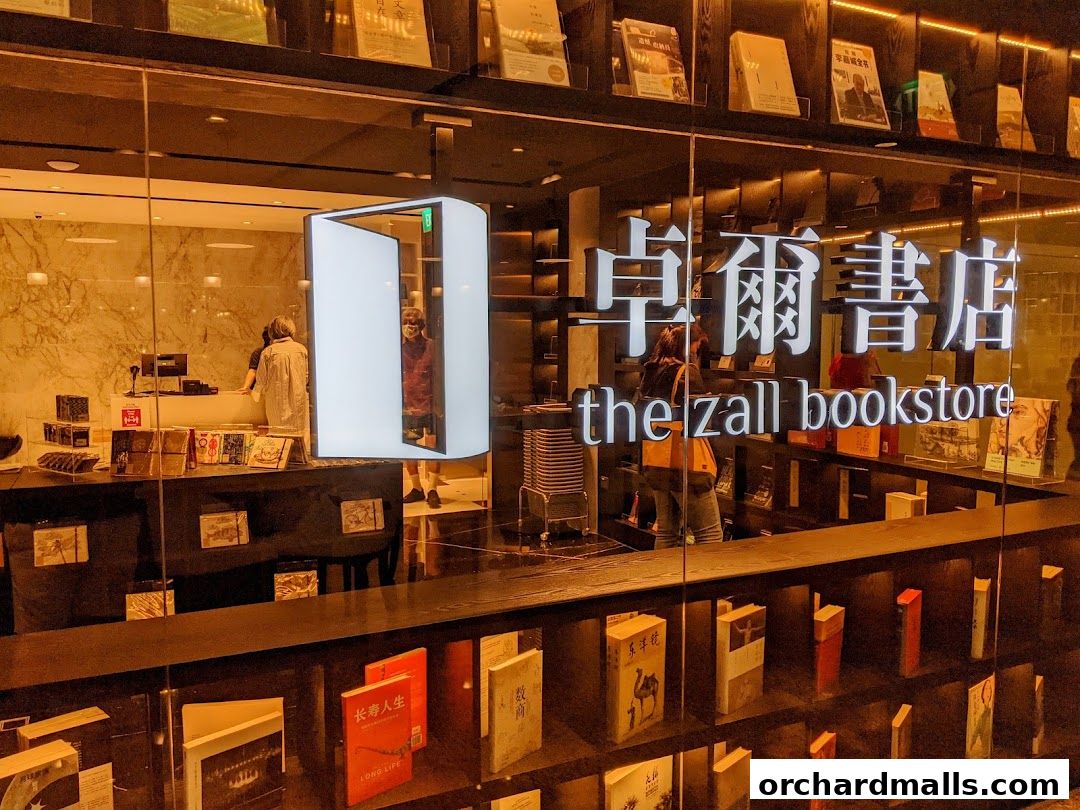 The Zall Bookstore entrance with books displayed on shelves and a modern illuminated sign.