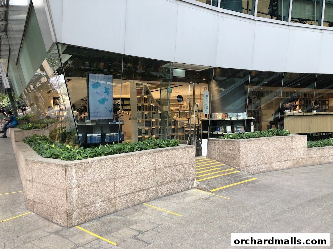 Exterior view of The Zall Bookstore with large glass windows showcasing books and interior seating.