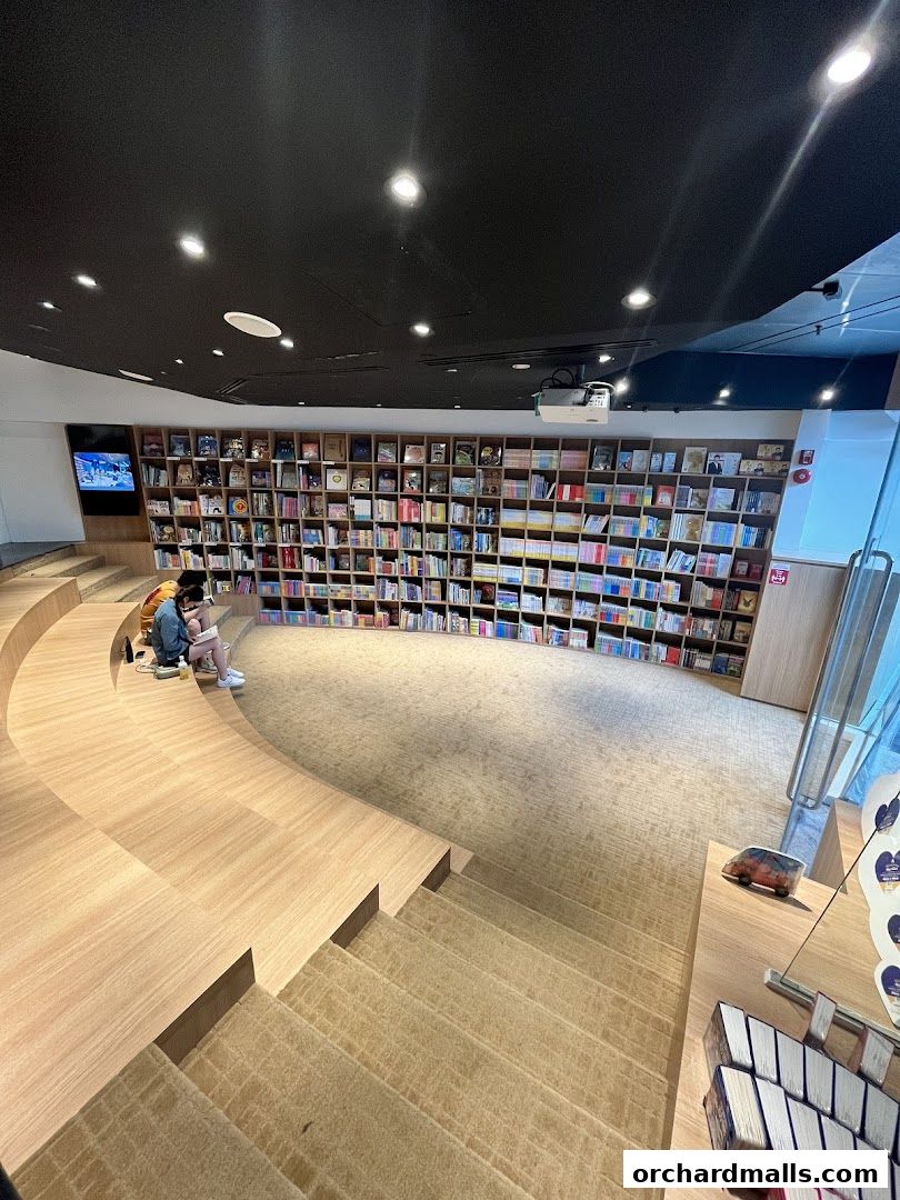 Interior of a bookstore with tiered seating and extensive bookshelves.