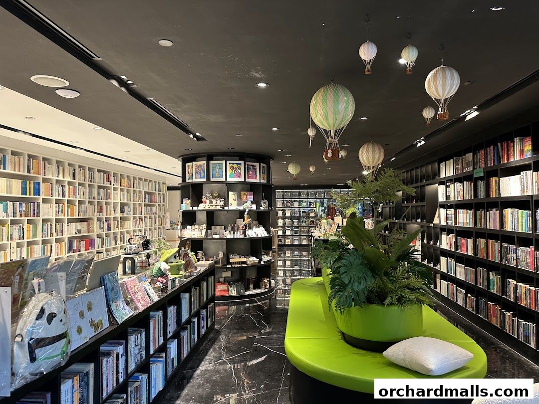 Interior of a modern bookstore with shelves full of books and decorative hot air balloons.