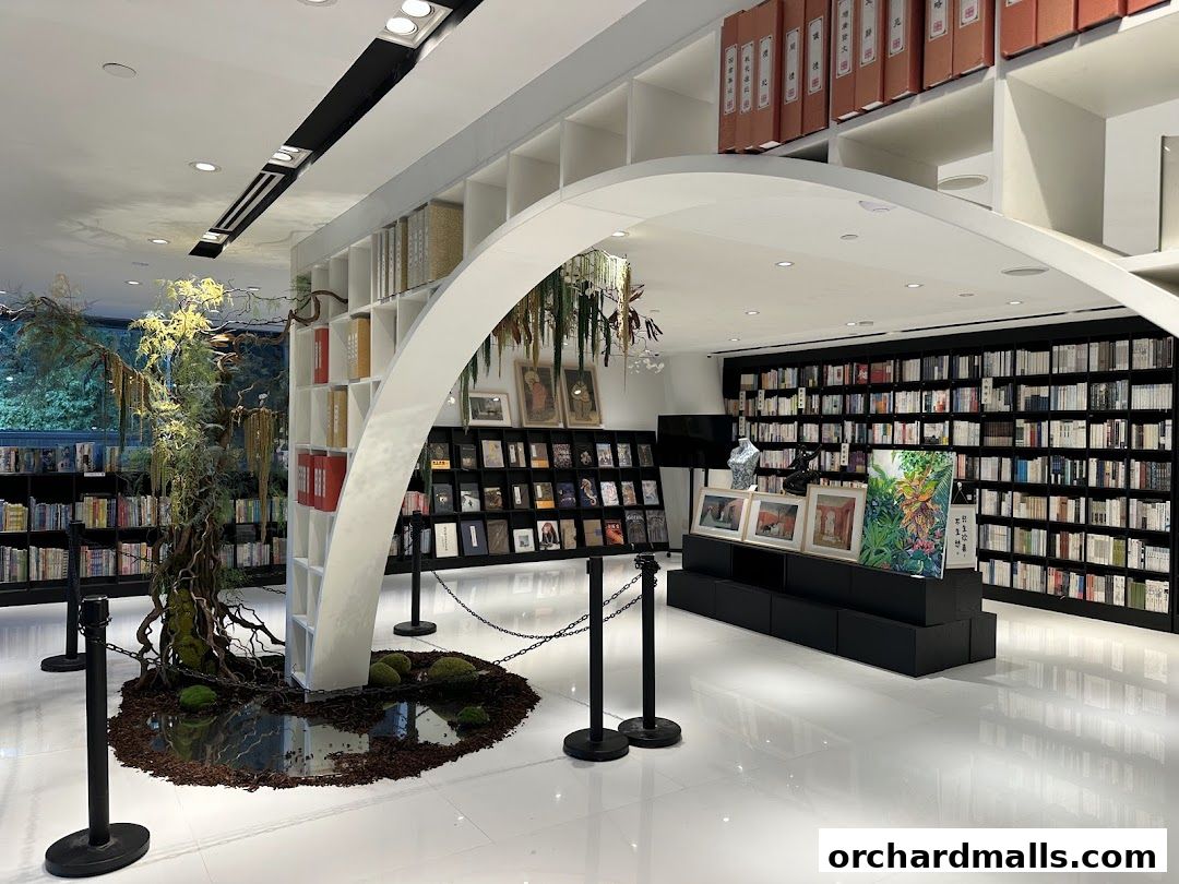 Interior of a modern bookstore with extensive bookshelves and a unique tree-like display.