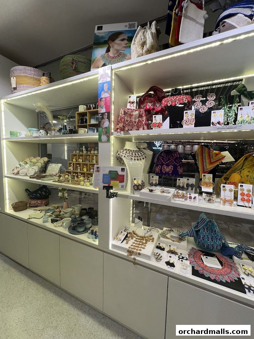 A well-lit display of artisanal jewelry, bags, and home decor items.