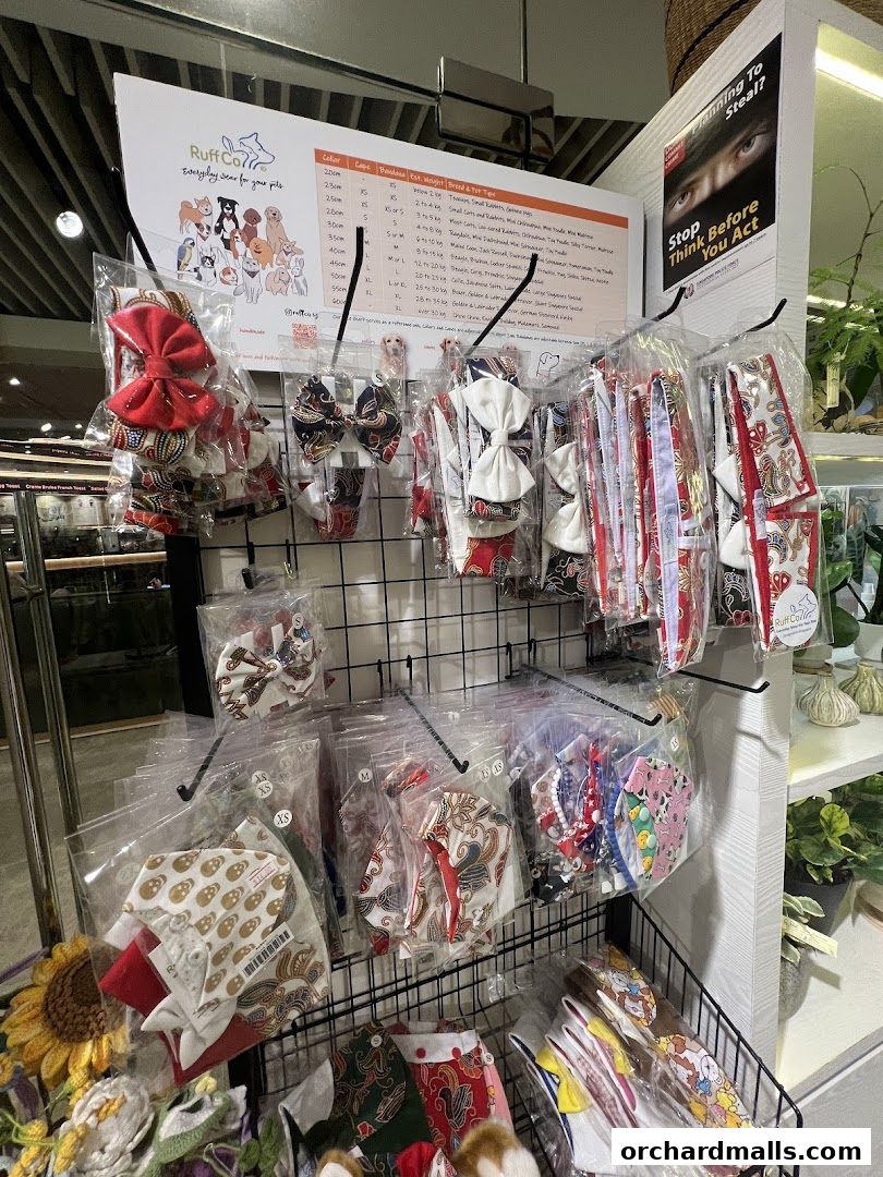 A display of pet accessories, including bandanas and bow ties, neatly packaged.