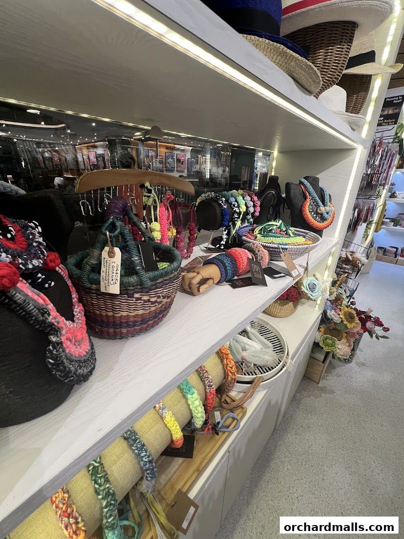 Shelves display colorful handmade accessories like necklaces, bracelets, and baskets.