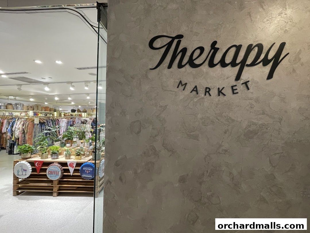 The entrance to Therapy Market at Wheelock Place, showcasing clothing and plants.