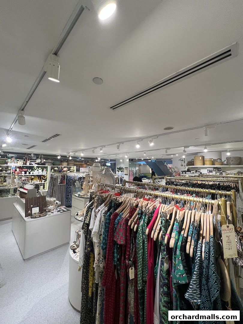 Interior view of a boutique shop displaying colorful dresses and accessories on racks.
