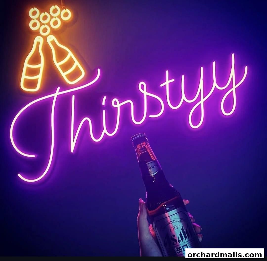 A neon sign spelling 'Thirstyy' with a hand holding a beer bottle.