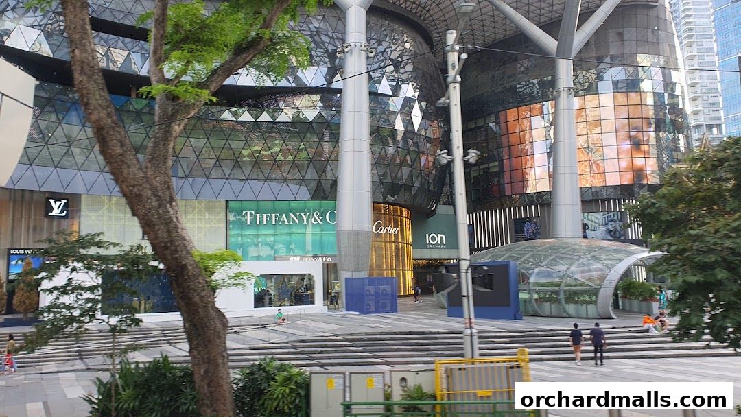 Exterior view of Tiffany & Co. and other luxury stores in a modern shopping mall.