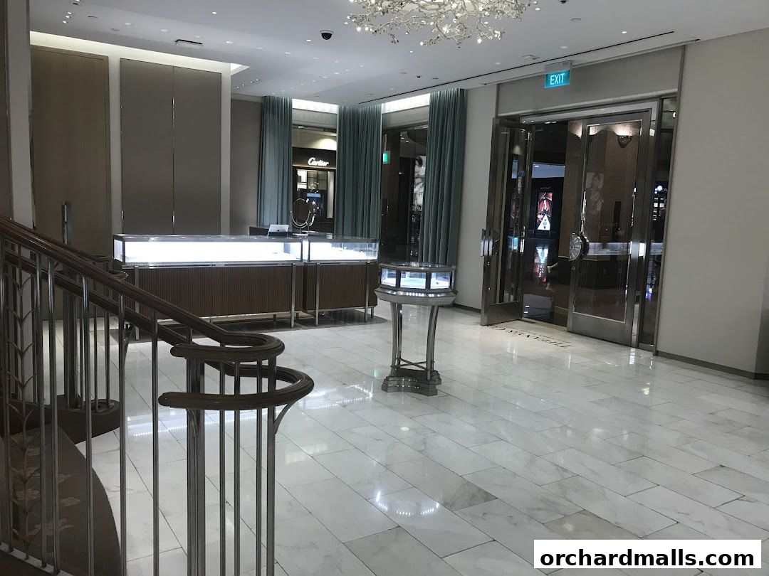Interior view of a Tiffany & Co. store with display cases and entrance doors.