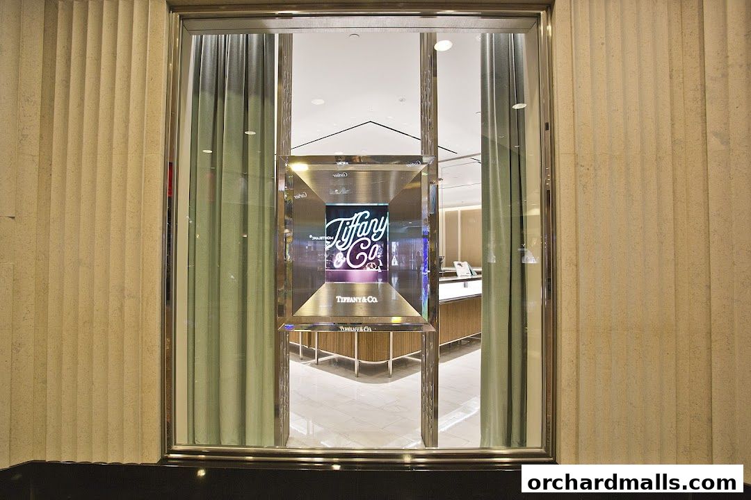 The elegant storefront of Tiffany & Co. features a modern display with the brand's iconic logo.