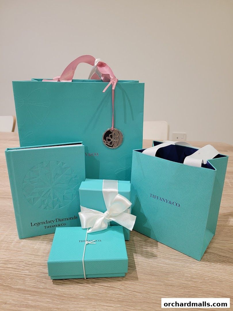 Tiffany & Co. branded shopping bags and boxes with ribbons.